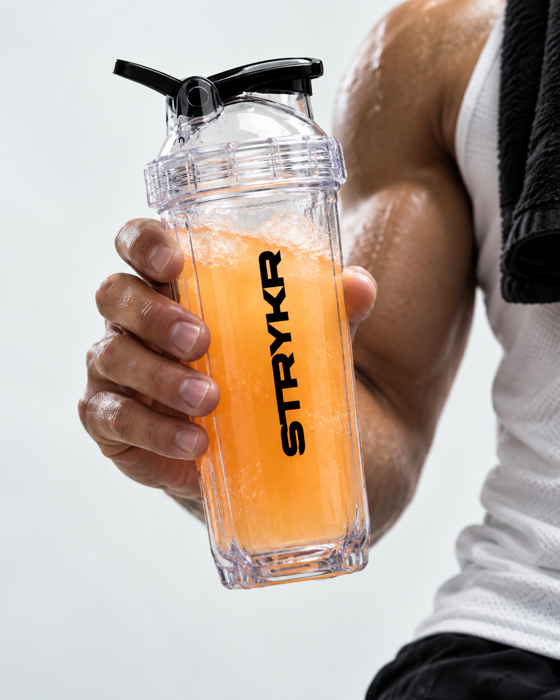 Athlete holding a STRYKR shaker